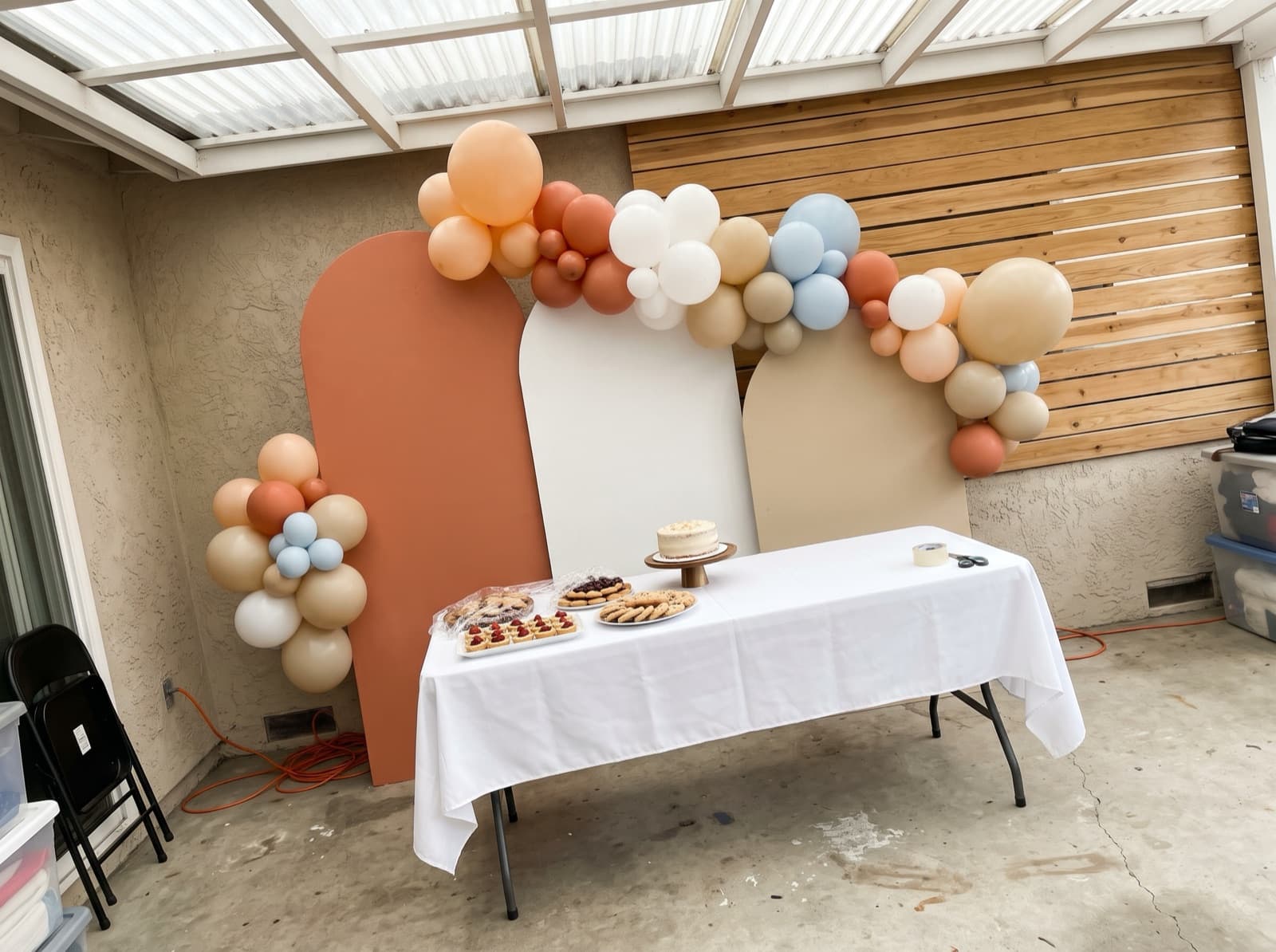 Chiara arched backdrop trio with a terracotta and sand garland