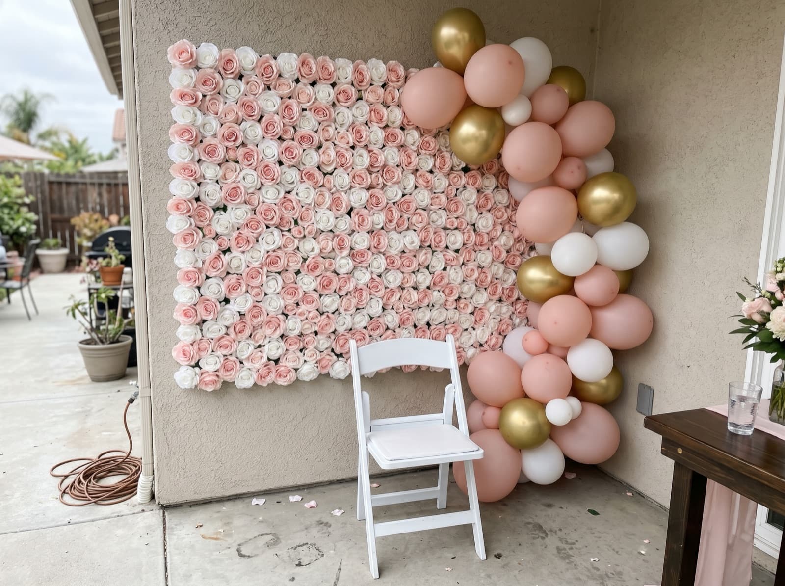 Flower wall backdrop with blush and gold balloons