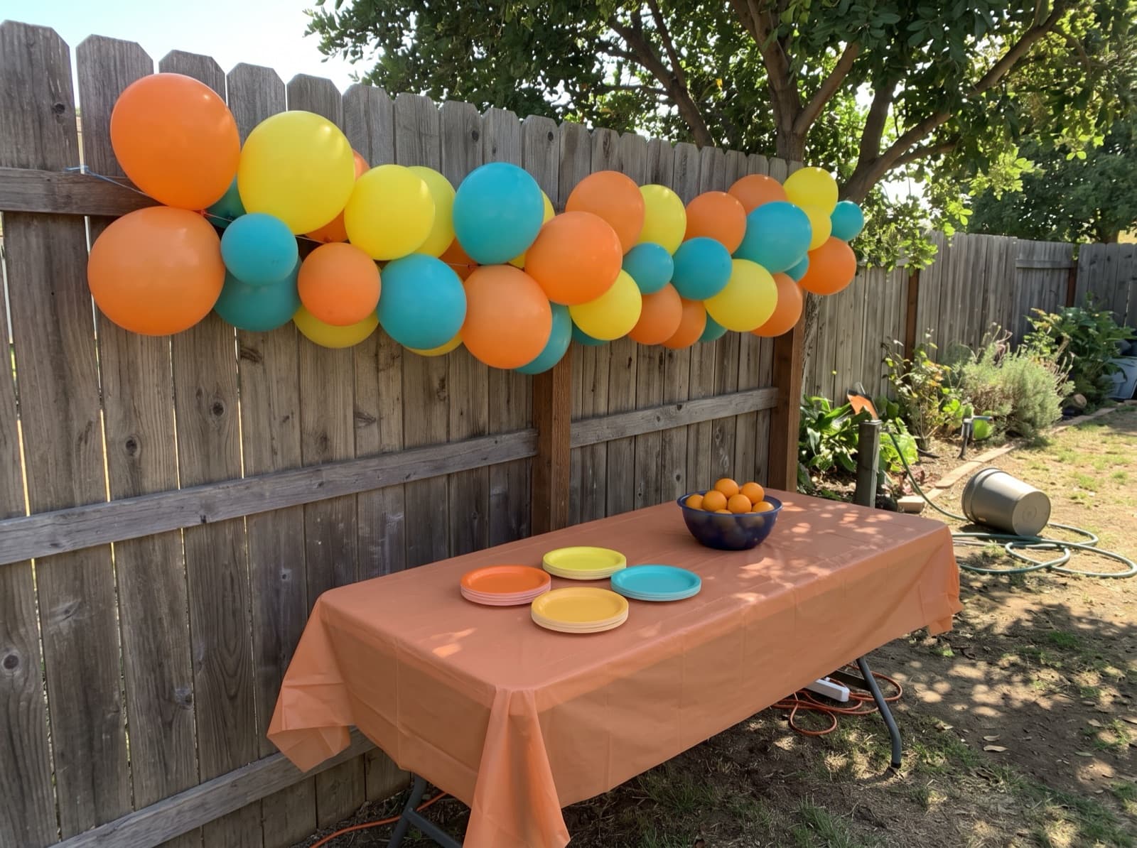 Grab-and-go balloon garland on a backyard fence