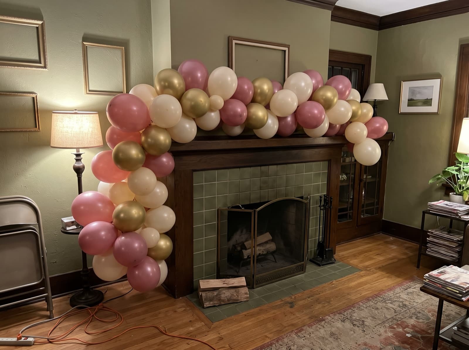 Organic balloon garland along a tiled fireplace mantel