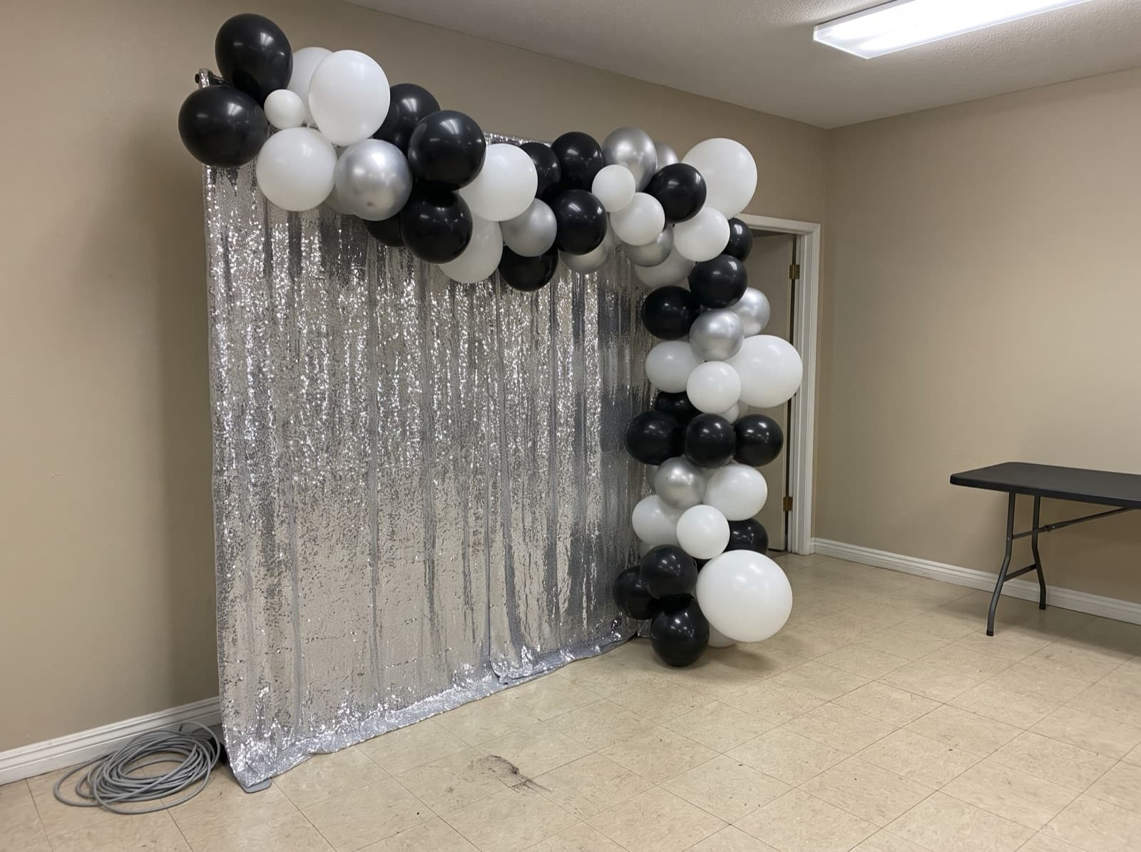 Balloon garland over a silver shimmer wall
