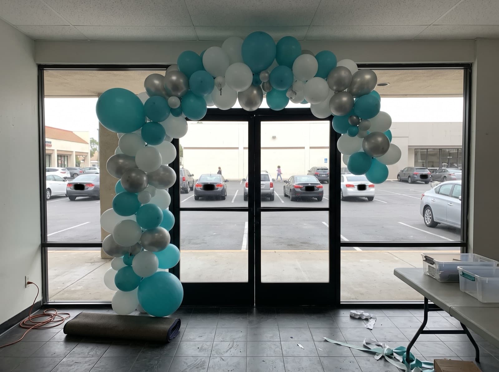 Giant balloon arch installation over a shop entrance