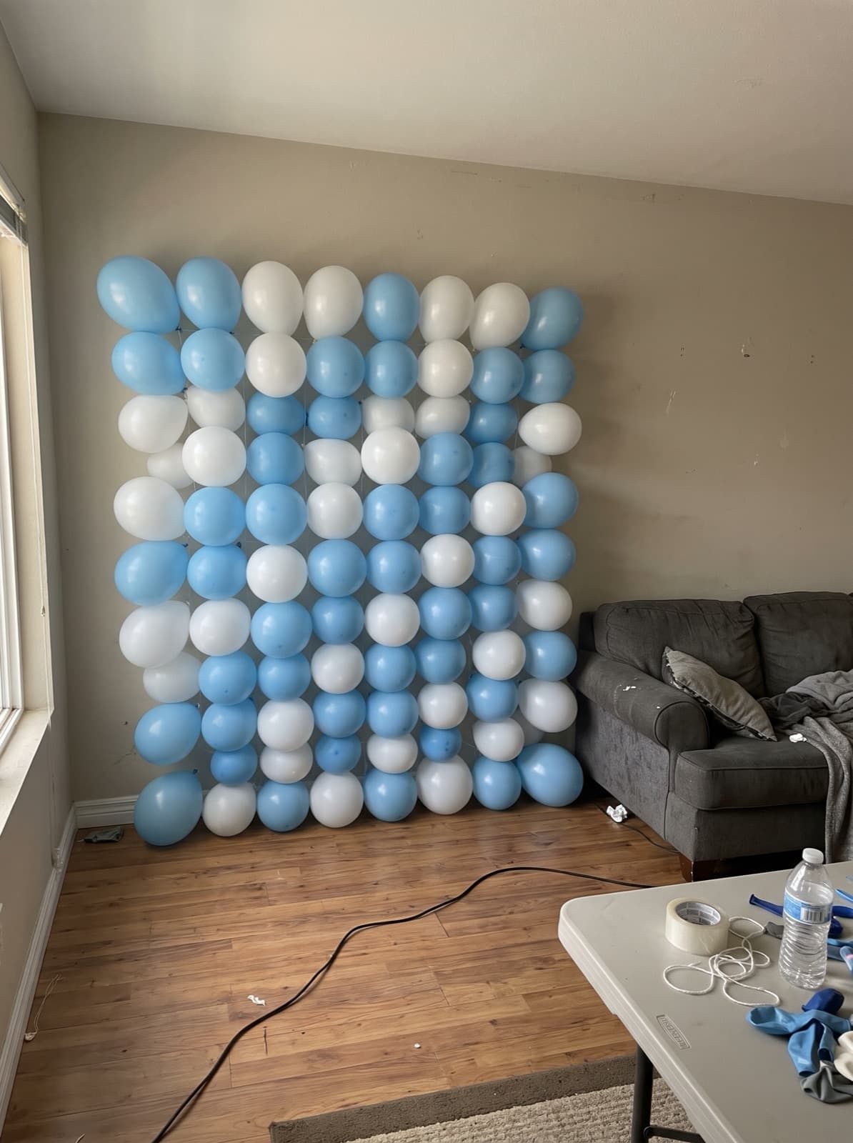 Grid balloon wall in a light blue and white checkerboard